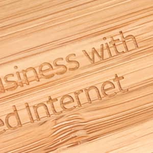 A close-up view of a bamboo surface engraved with text. The bamboo has a natural light brown colour.