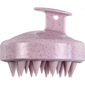 A pink hair scalp massager with soft, pointed tips for gentle massage, featuring a hanging hook.