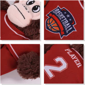 A plush toy monkey wearing a red basketball jersey with a logo and the number 2 on it.