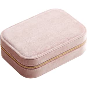 A pink velvet jewellery box with a compartment and a gold zipper. It features a soft, textured exterior.