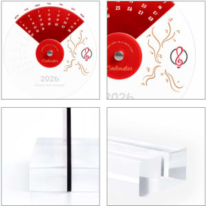 An acrylic desk calendar featuring a red and white design with musical motifs and a sleek, clear base.