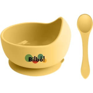 A yellow silicone kids' suction bowl and spoon, featuring a logo, designed for stable feeding.