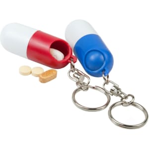 A red and white pill capsule keychain and a blue and white pill capsule keychain, each with a keyring attachment.