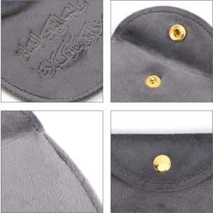 A grey velvet jewelry pouch featuring a snap button closure and a soft interior. Includes a logo.