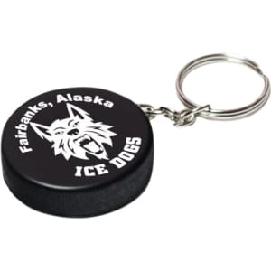 A black hockey puck stress reliever with a silver keyring and a logo featuring a wolf design.
