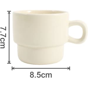 A stackable ceramic mug in off-white, featuring a single handle and marked measurements.