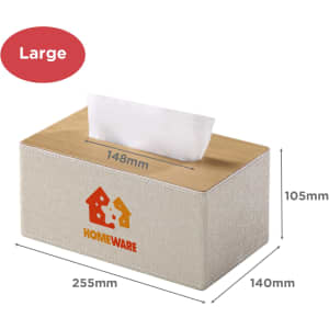 A large tissue box with a light beige fabric exterior and wooden top, featuring a logo. Dimensions are listed.
