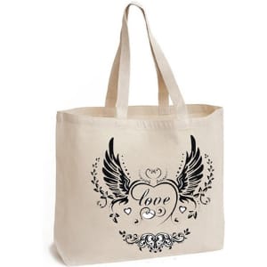 A cream calico bag with a gusset and a decorative black print featuring wings and a heart design. It has two short handles and a logo.