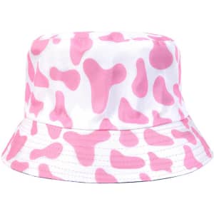 A pink and white bucket hat featuring a cow print design, with a simple logo on it.