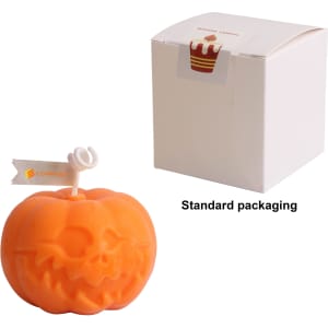 An orange pumpkin-shaped candle with a carved face, accompanied by a standard packaging box.