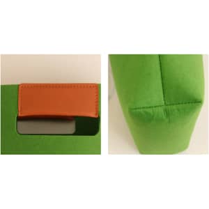A green felt tote bag featuring a brown leather handle and a structured shape. Includes a logo on the side.
