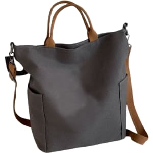 A grey vintage style canvas bag with brown straps and two side pockets, featuring a small logo.