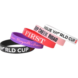 Four debossed silicone wristbands in black, pink, purple, and white, featuring various designs and a logo.