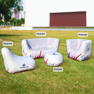An inflatable two-seat sofa in white with colourful accents, accompanied by additional inflatable seating and accessories.