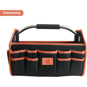 A black tool carrier bag with orange accents, featuring multiple pockets and a metal handle. It has a logo on it.