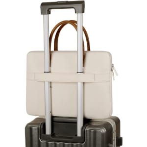 A cream PU handle laptop bag with a zippered outer pocket attached to a suitcase handle. The bag features a branding logo.