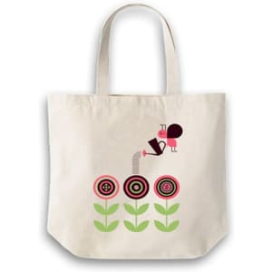 A calico bag with a short handle featuring a design of flowers and a character, in a light cream colour.