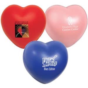 Three heart-shaped stress relievers in red, pink, and blue, featuring various logos.