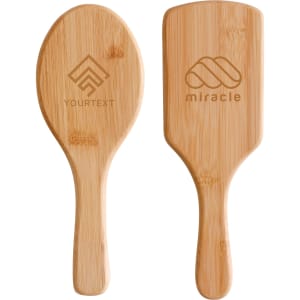 A bamboo hairbrush featuring a smooth, rounded design with a handle. It has two sides, each with different engravings.