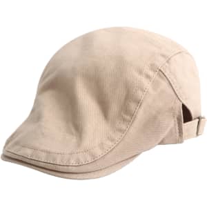 A beige beret hat with a curved brim and a strap at the back, featuring a logo on the side.