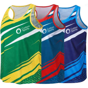 A collection of three polyester sublimated sports singlets in yellow, red, and blue with a branded logo on each.