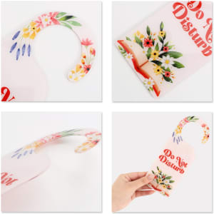 A custom-shaped acrylic door hanger featuring a floral design in pink, yellow, and blue with a handle for easy hanging.