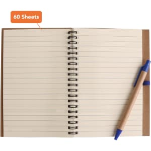A Kraft notebook with a brown cover, spiral binding, and a blue ballpoint pen, featuring lined pages.