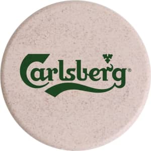 A round wireless charger in a light beige colour with a logo prominently displayed.