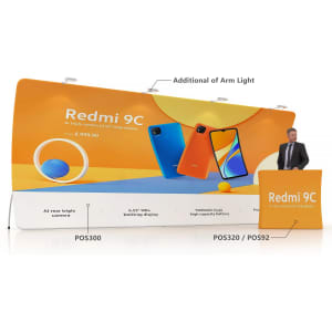 A large U-shaped tension fabric display wall featuring orange and blue colours, with a promotional stand and a person beside it.