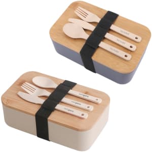 A lunch box set featuring a bamboo cover, with two colour options—blue and cream—along with wooden utensils and a strap.
