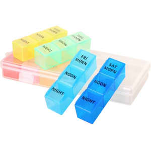 A set of colourful pill organisers in blue, yellow, and pink, housed in a clear container, featuring compartments for days and times.