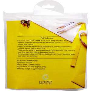 A travel toiletry kit in a clear bag with a yellow background, containing empty bottles and accessories.