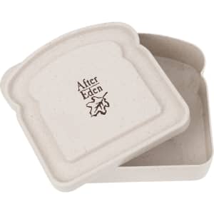 A portable lunch box in a light beige colour, featuring a bread-shaped design and a logo.
