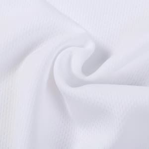 A close-up of white polyester fabric with a textured pattern, featuring a smooth, soft appearance.