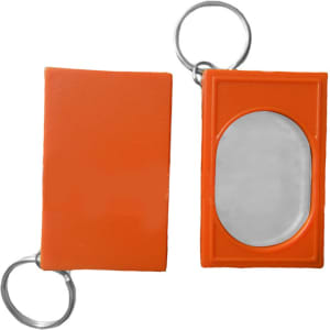 An orange pet training clicker with a keyring attachment and an oval mirror on one side.