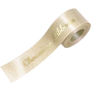 A roll of glitter gold satin ribbon with a shiny finish and a decorative text pattern.