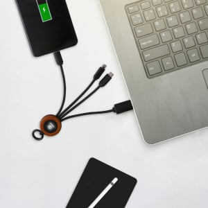 A round light-up charging cable in black and brown connected to a smartphone and laptop on a white surface.