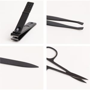 A portable manicure set featuring black nail clippers, tweezers, a nail file, and scissors, all compactly arranged.