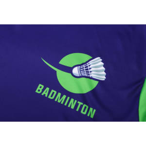 A purple and green badminton shirt featuring a shuttlecock graphic and a logo.