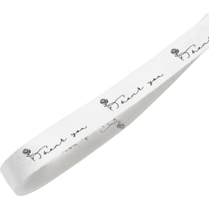 A white cotton ribbon featuring black printed text and a rose design, with a logo on the side.