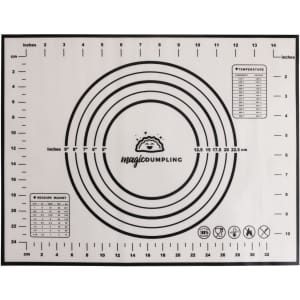 A silicone pastry mat in white with black measurement markings and circles, featuring a logo in one corner.