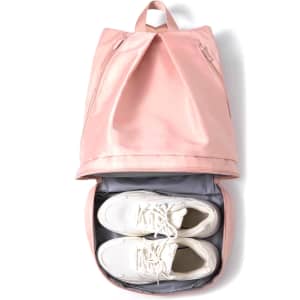 A pink backpack with a top compartment and a grey lower section containing a pair of white shoes.
