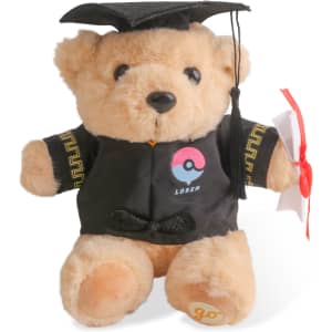 A tan plush bear wearing a graduation cap and gown, holding a diploma. The bear has a logo on its gown.
