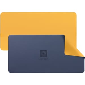 A PU leather desk mat featuring a yellow surface on one side and a navy blue underside, with a logo in the centre.