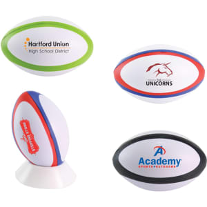 A collection of four stress rugby balls, featuring various colours and logos, with a mix of designs including green, blue, and red accents.