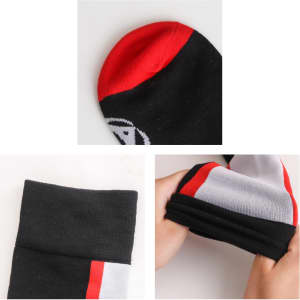 Knee high socks in black with red and white accents, featuring a branded logo. Close-up of toe and cuff details.