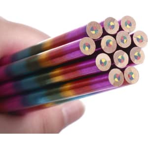 A set of long, four-colour pencils in a hand, showcasing vibrant purple, blue, green, and orange hues at the ends.