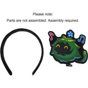 A black felt headband with an attached cartoonish green character design featuring musical notes. Assembly required.