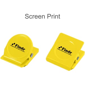 A pair of bright yellow metal magnetic clips with a logo, one circular and one rectangular.