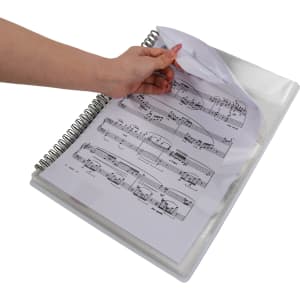 A loose-leaf folder with a transparent cover, showcasing sheet music inside and a hand turning the pages.